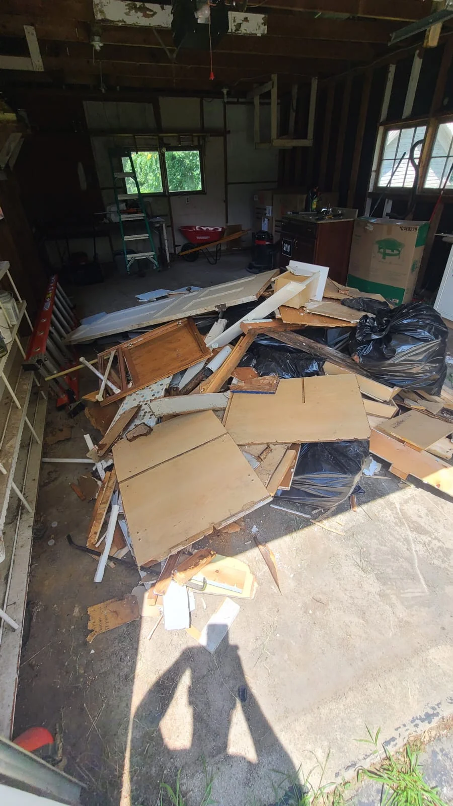 Garage junk removal before service - cluttered garage full of items